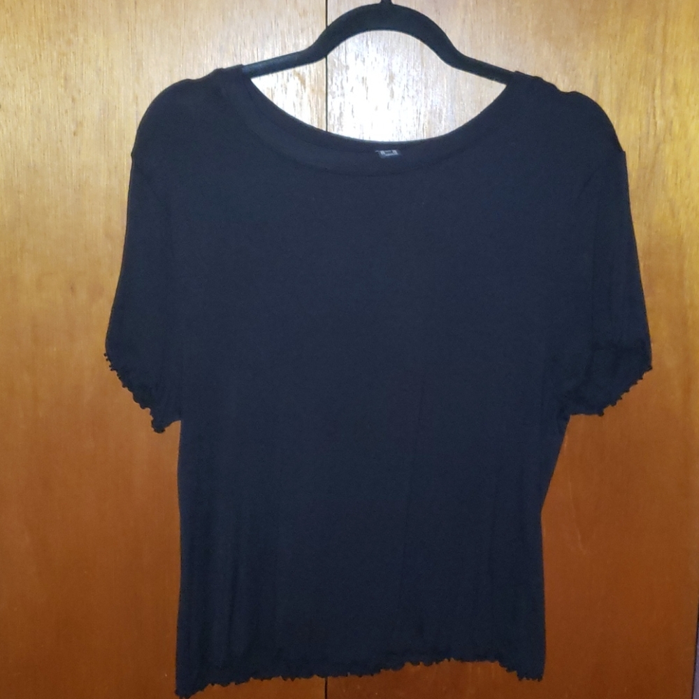 Black spandex/rayon with ruffled edges.